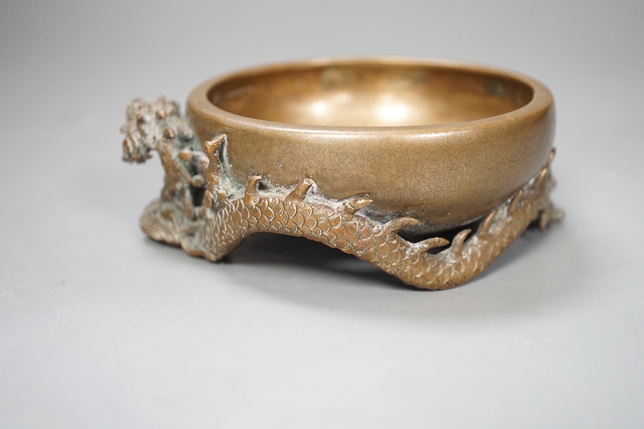 A Chinese or Japanese bronze ‘dragon’ dish, 13cm